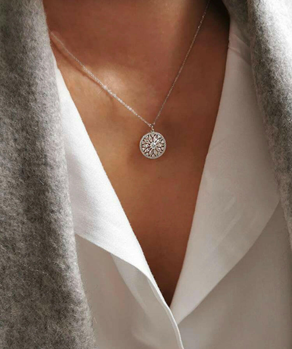 This stylish pendant necklace is crafted from gold-plated sterling silver and inlaid with sparkling cubic zirconia stones. The eye-catching sunflower design brings a hint of nature to your outfit. A perfect accessory for any special occasion.