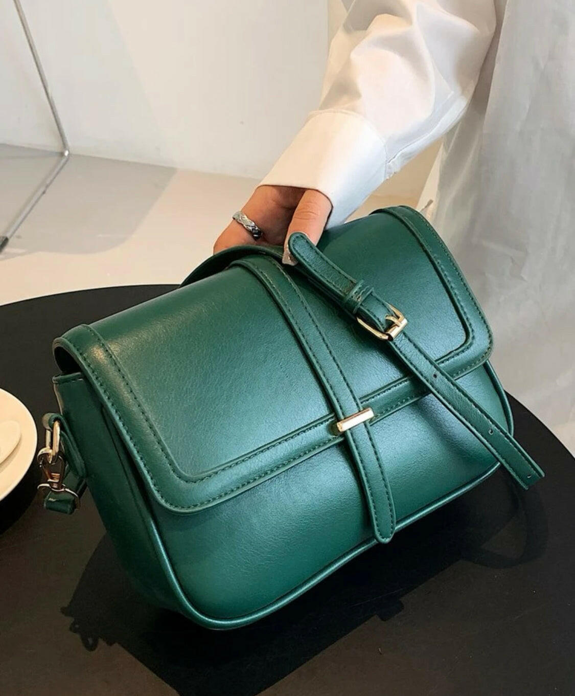 This eye-catching Green Metal Detail Flap Square Bag features a chic metallic trim and a contemporary square silhouette, making it the perfect addition to any wardrobe. The spacious interior is ideal for storing everyday items, and the hardware detail adds an edgy finishing touch.