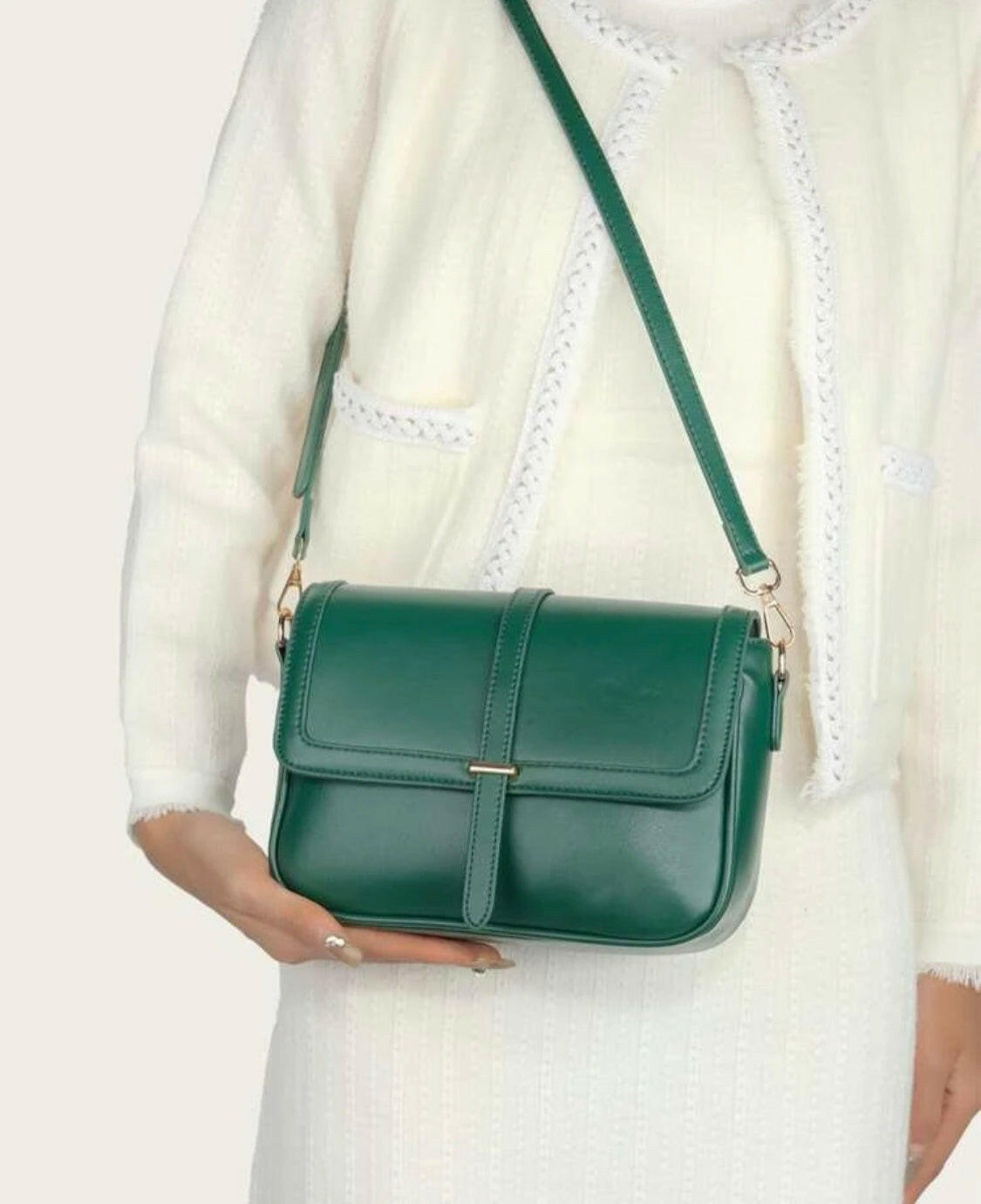 This eye-catching Green Metal Detail Flap Square Bag features a chic metallic trim and a contemporary square silhouette, making it the perfect addition to any wardrobe. The spacious interior is ideal for storing everyday items, and the hardware detail adds an edgy finishing touch.