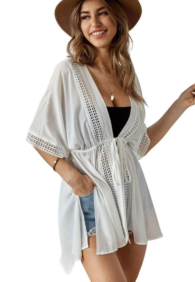 Plain tie front kimono, a sleek and versatile beachwear layer. This kimono features a simple design with a tie front closure. Its minimalist style and neutral color make it an easy-to-pair option for layering over swimwear. The tie front detail adds a touch of elegance, enhancing your beach ensemble with understated sophistication.