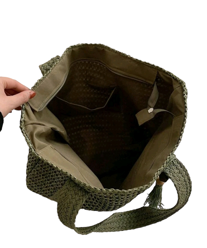 A large capacity straw bag with tassel decor, designed for vacations and leisure. The bag is made of woven straw material and features a spacious interior. It is adorned with decorative tassels for added style. The bag is perfect for carrying your essentials during vacation or outings, adding a touch of boho chic to your look.