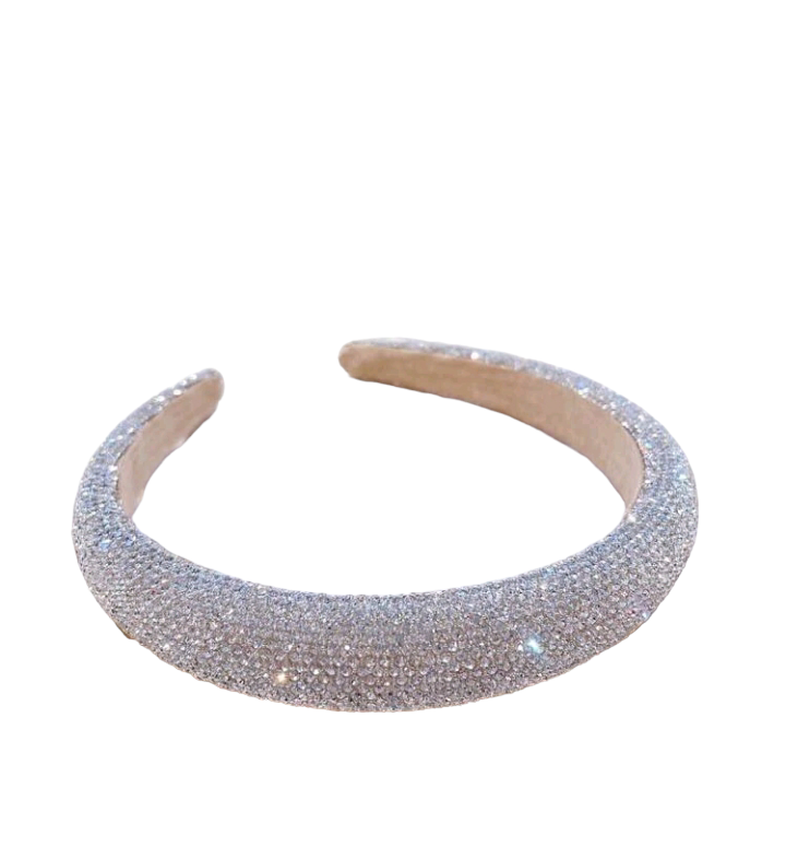 A glamorous wide headband in silver adorned with sparkling rhinestone decorations, elevating your hair accessory game with a touch of elegance and shine.
