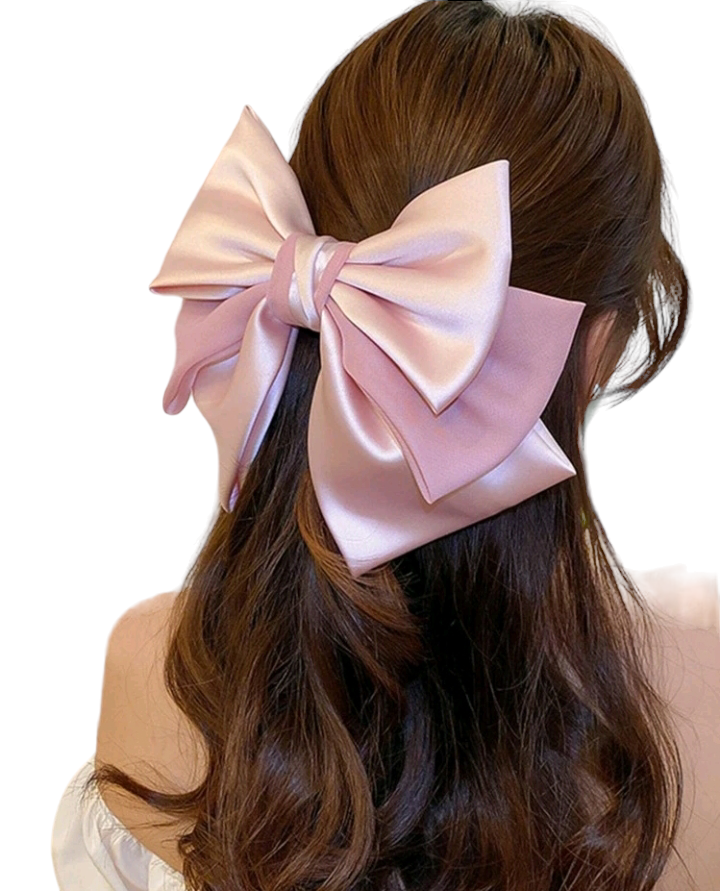 A fashionable pink hair clip embellished with a charming bow design. This delightful hair accessory adds a touch of style and whimsy to your look, making it a perfect choice for elevating your hairstyle with a playful and trendy accent.