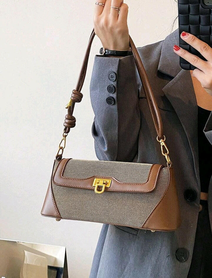 Crafted with intricate metal detailing, this flap baguette bag adds a touch of sophistication to any outfit. The rich brown color adds warmth and versatility, making it a stylish choice for any occasion. The structured design ensures your belongings stay organized and secure, while the adjustable strap offers customizable comfort. Elevate your fashion game with this must-have accessory.