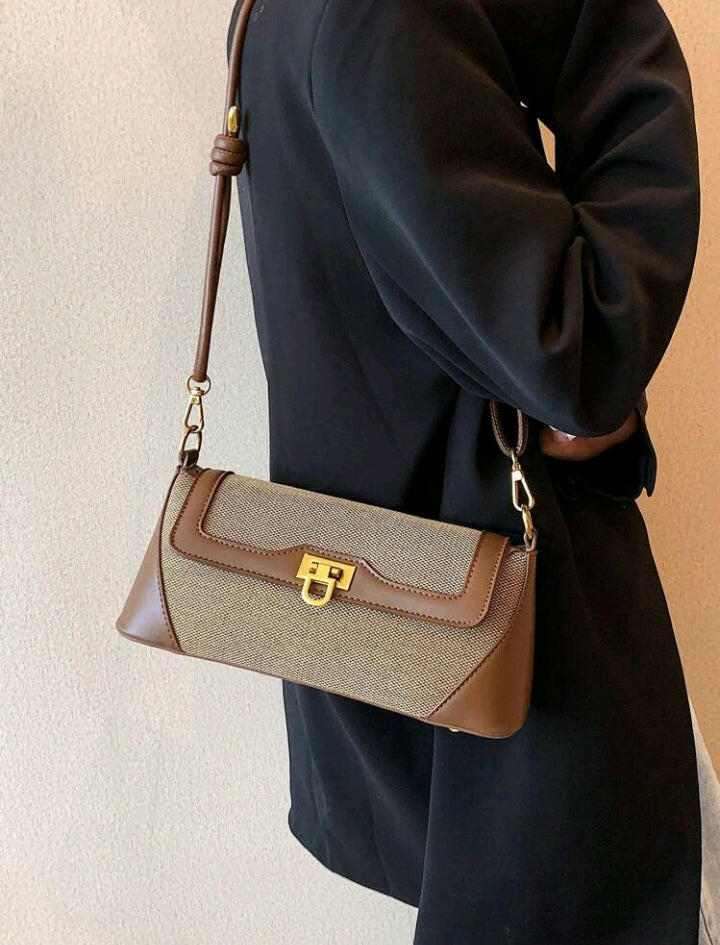 Crafted with intricate metal detailing, this flap baguette bag adds a touch of sophistication to any outfit. The rich brown color adds warmth and versatility, making it a stylish choice for any occasion. The structured design ensures your belongings stay organized and secure, while the adjustable strap offers customizable comfort. Elevate your fashion game with this must-have accessory.