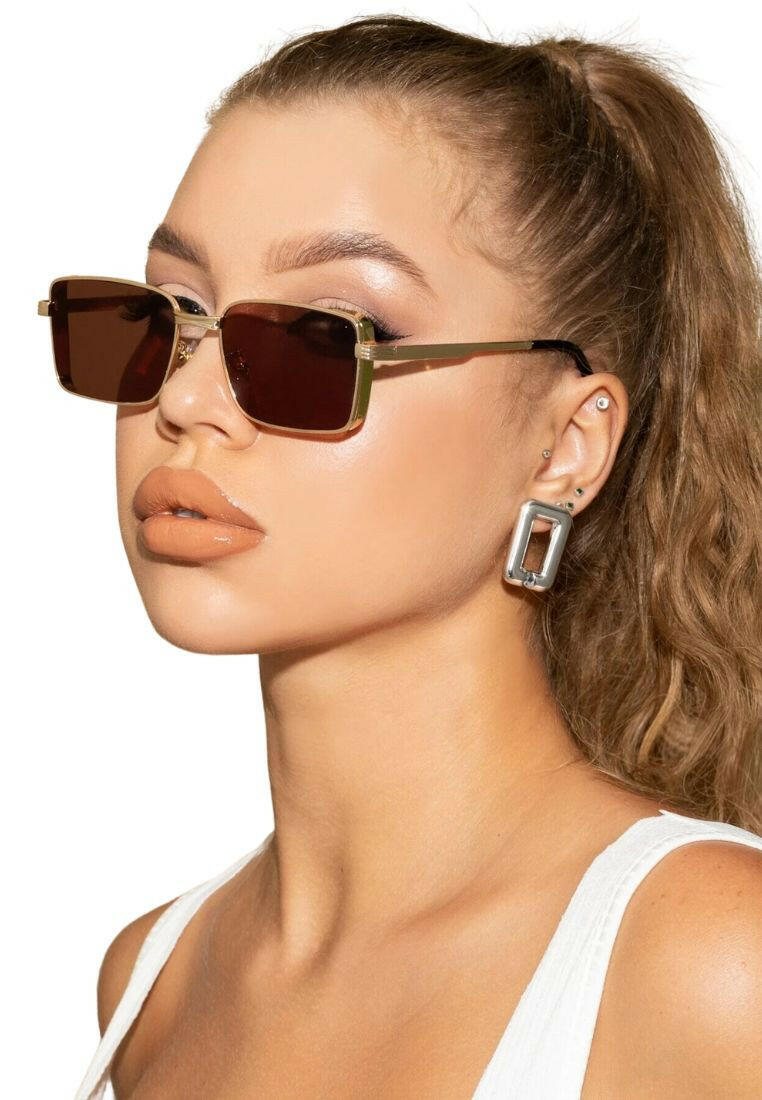 Pair of Tinted Lens Sunglasses with a fashionable and practical design. These sunglasses feature lenses with a tinted shade, combining style and sun protection for a versatile eyewear choice.