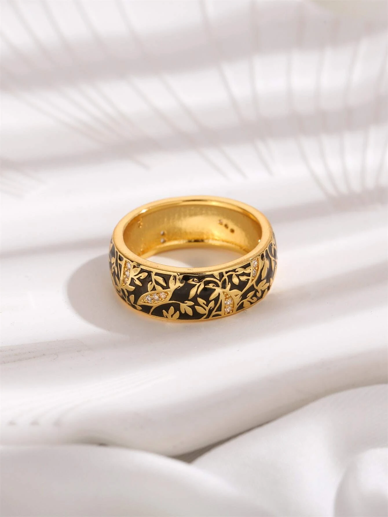 Elegant black flower detail ring made of copper, showcasing intricate floral design. The ring features a delicate and artistic arrangement of petals, providing a sophisticated and stylish appearance. Crafted from copper, this piece of jewelry adds a touch of elegance and beauty to any outfit. A versatile and fashionable accessory that can complement various styles and occasions.