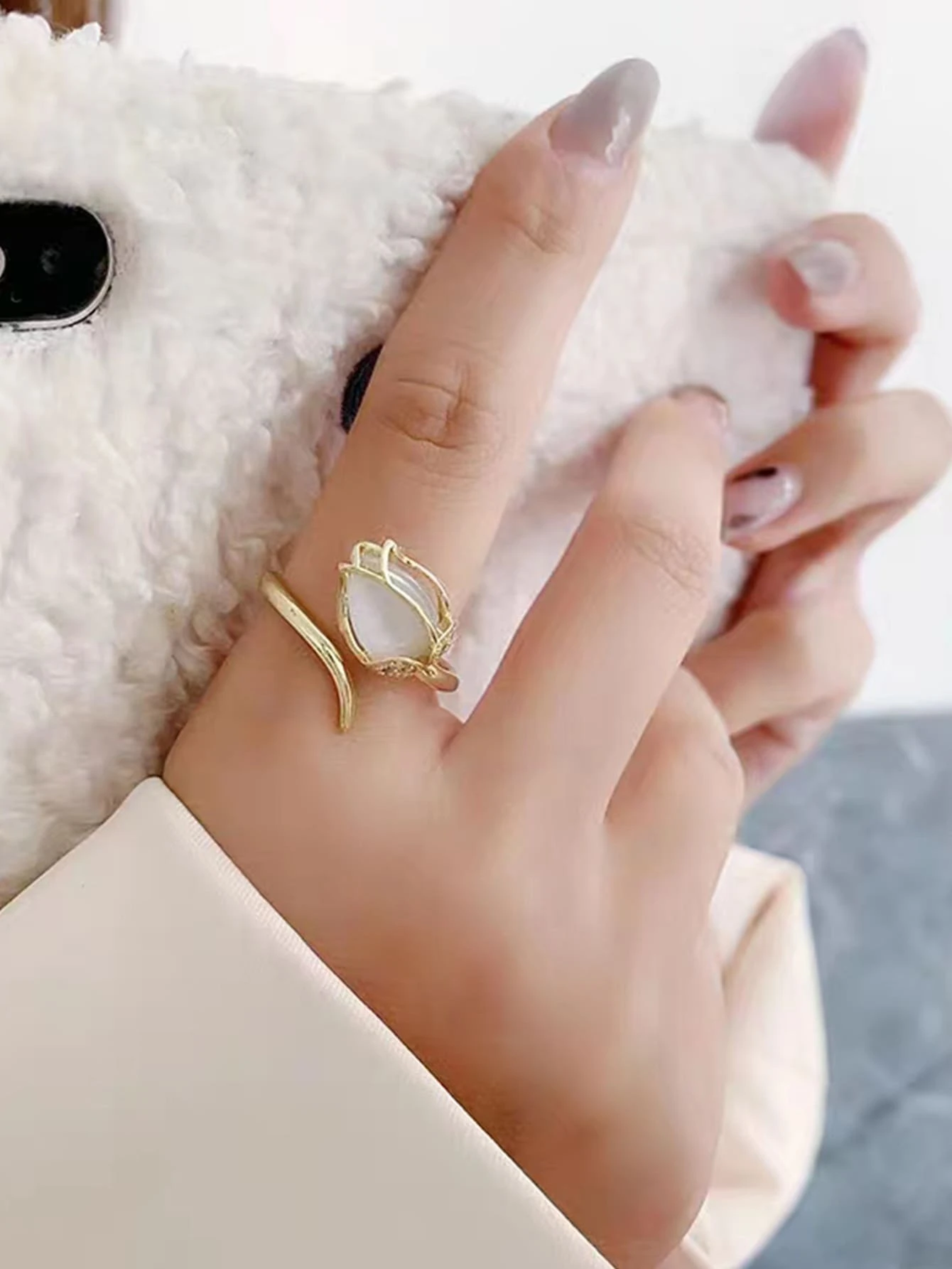 A distinctive flower decor cuff ring crafted from copper, showcasing intricate floral details. The ring features an open cuff design with a flower motif on one end, creating a stylish and artistic look. The warm copper tone and delicate floral embellishments add a touch of elegance and charm to this accessory. A fashionable and versatile piece of jewelry that can elevate various outfits