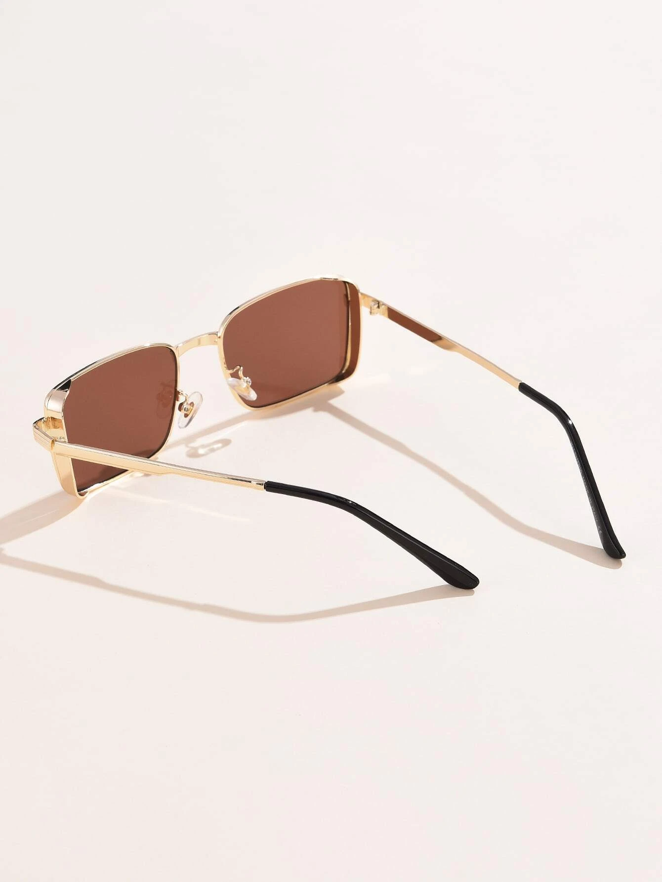 Pair of Tinted Lens Sunglasses with a fashionable and practical design. These sunglasses feature lenses with a tinted shade, combining style and sun protection for a versatile eyewear choice.