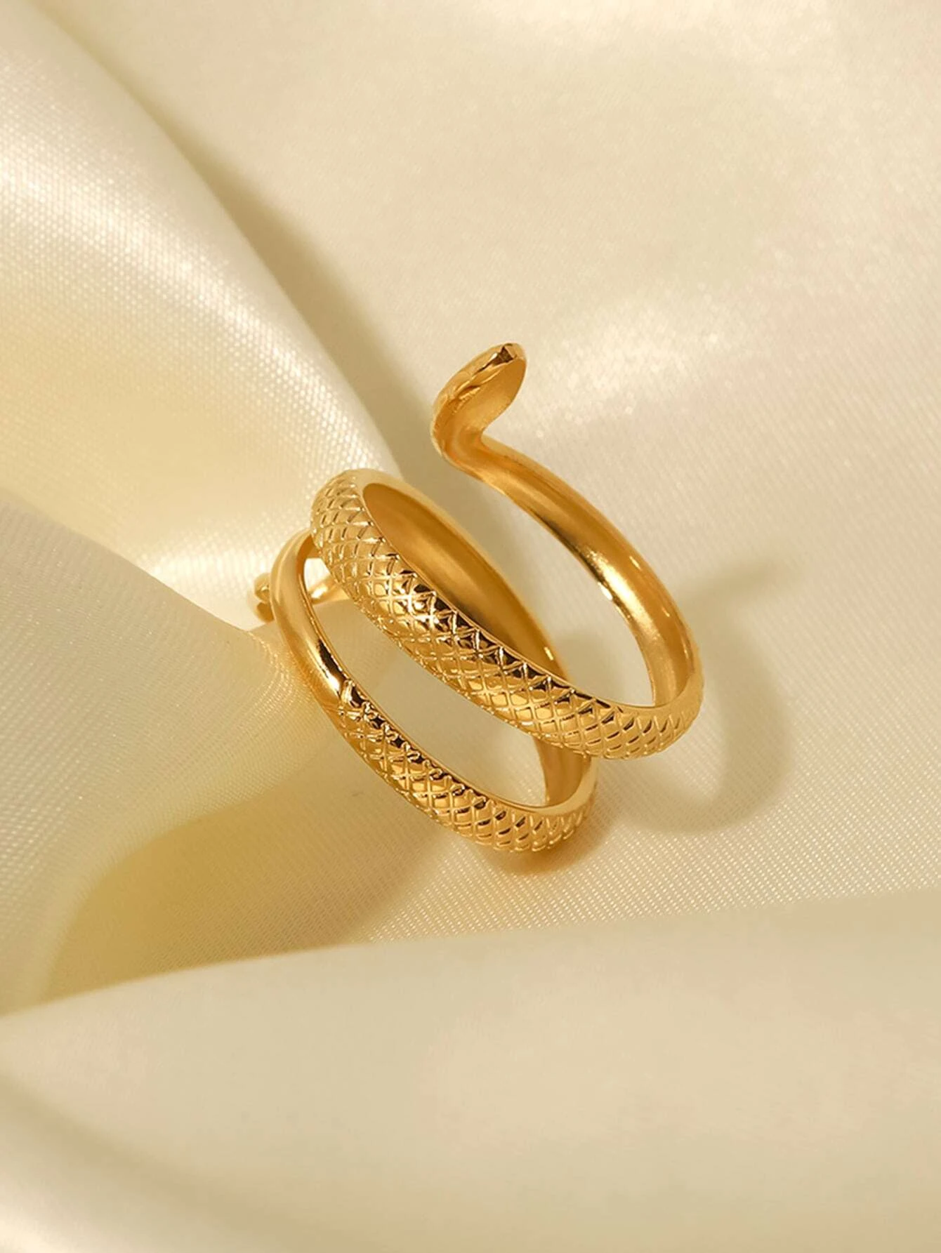 A modern stainless steel wrap ring with a snake design. The ring features an open-ended wrap style that showcases a snake motif at the ends. The snake design is intricately detailed, creating a stylish and edgy look. Crafted from stainless steel, this ring is a versatile and fashionable accessory that adds a touch of intrigue and sophistication to any outfit.