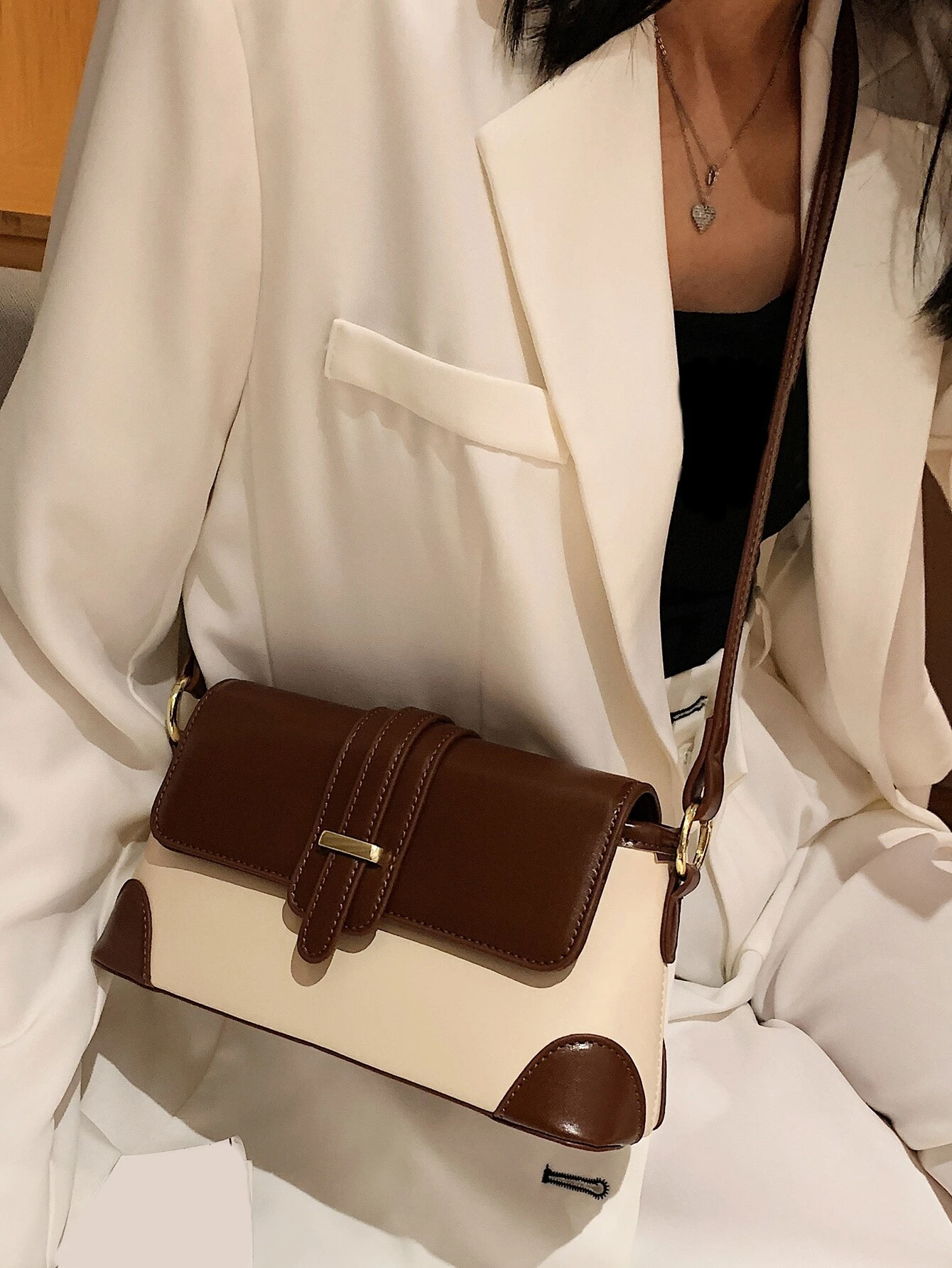 Square bag with colorblock flap design. This accessory boasts a modern and dynamic look, featuring contrasting color panels that add visual interest and style to your ensemble.