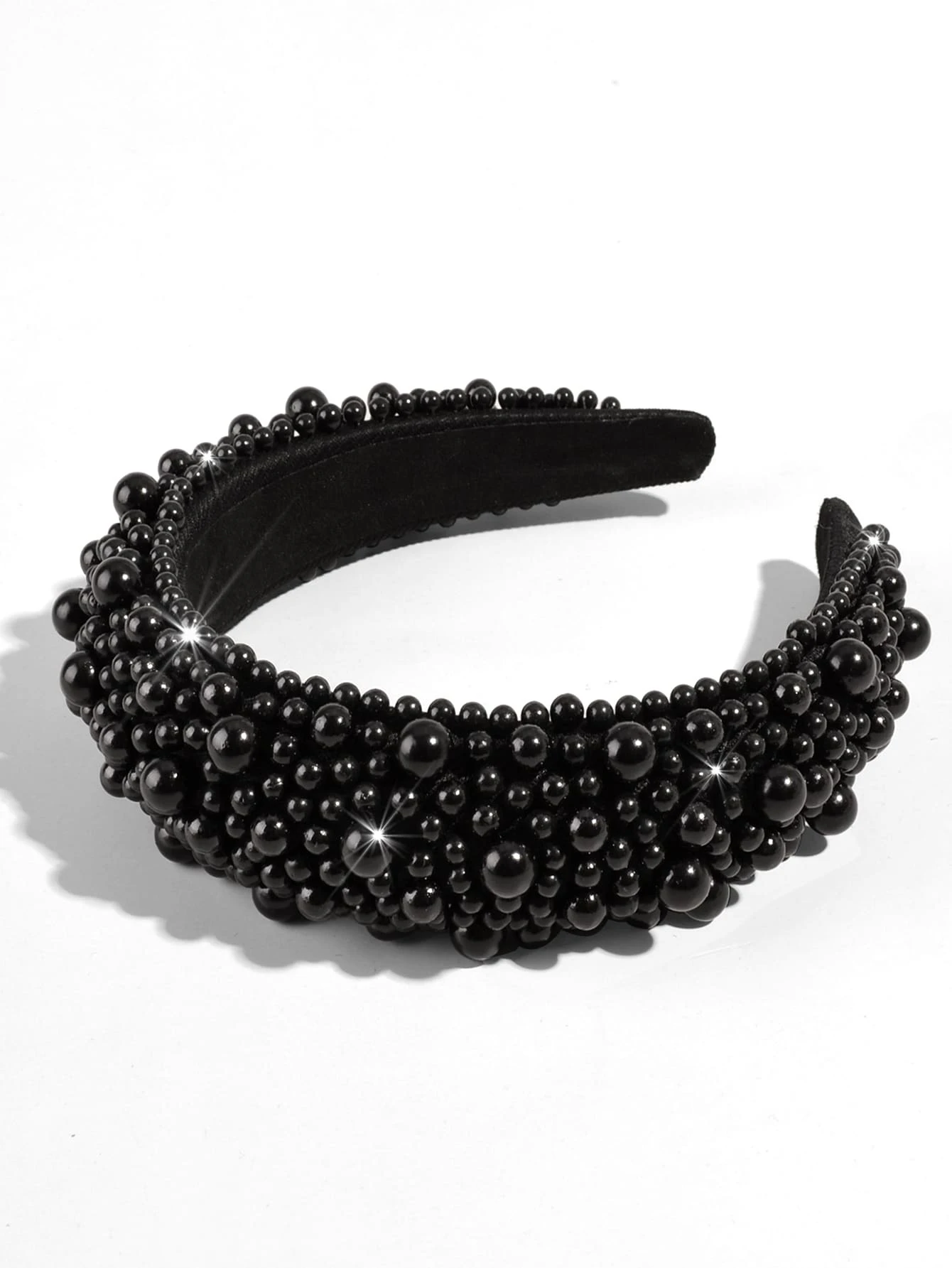 A black headband adorned with bead decorations, offering a chic and stylish accessory for your hair.