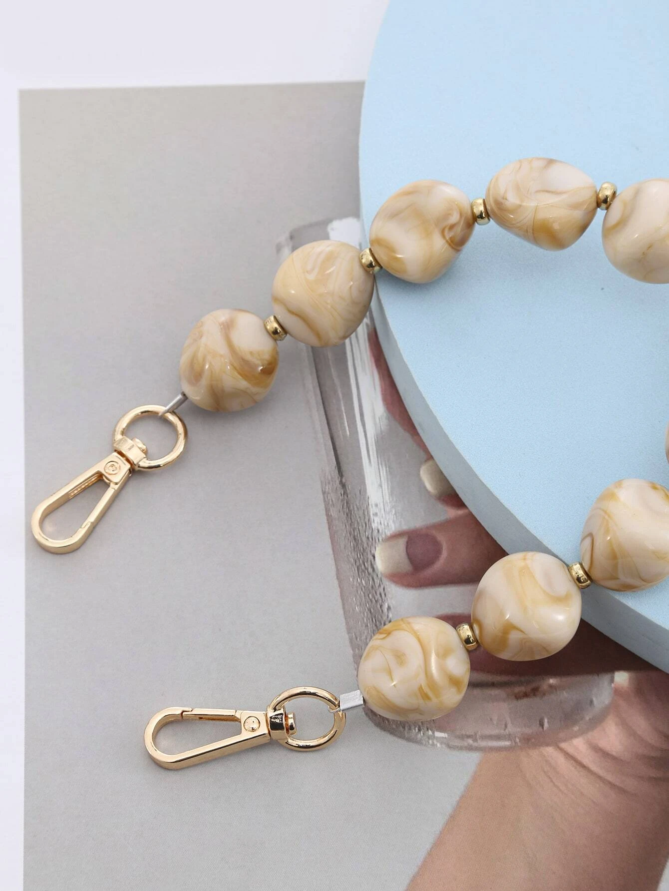 Bag strap adorned with stylish graphic beading. This accessory adds a touch of artistic design to your bag, with its intricate beadwork enhancing its visual appeal.