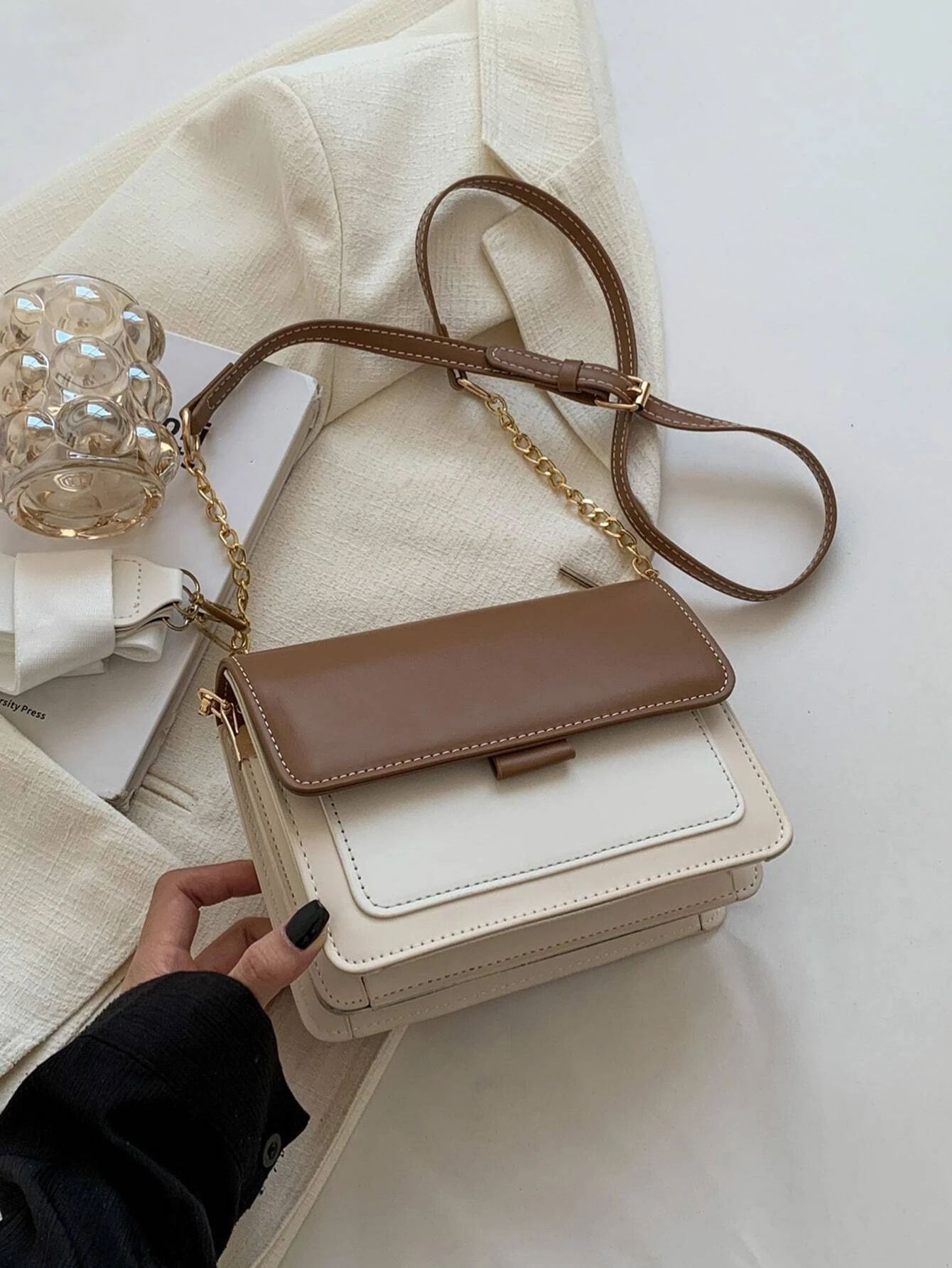 Mini square bag with color block flap design. This accessory combines modern design with vibrant color contrasts, offering a chic and stylish way to carry your essentials.