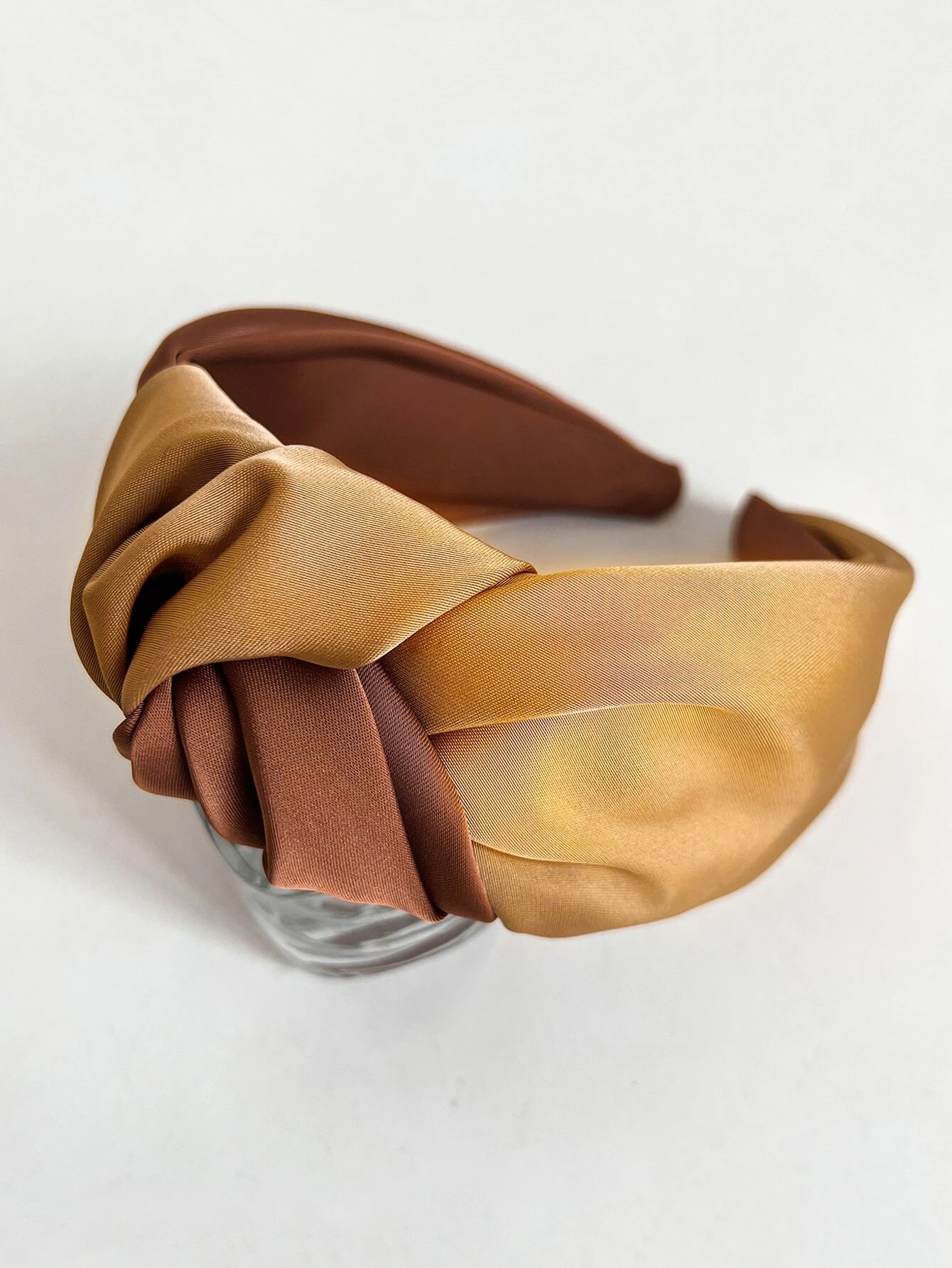 Wide headband with a two-tone knot detail, providing a stylish and eye-catching accessory to enhance your hair look.