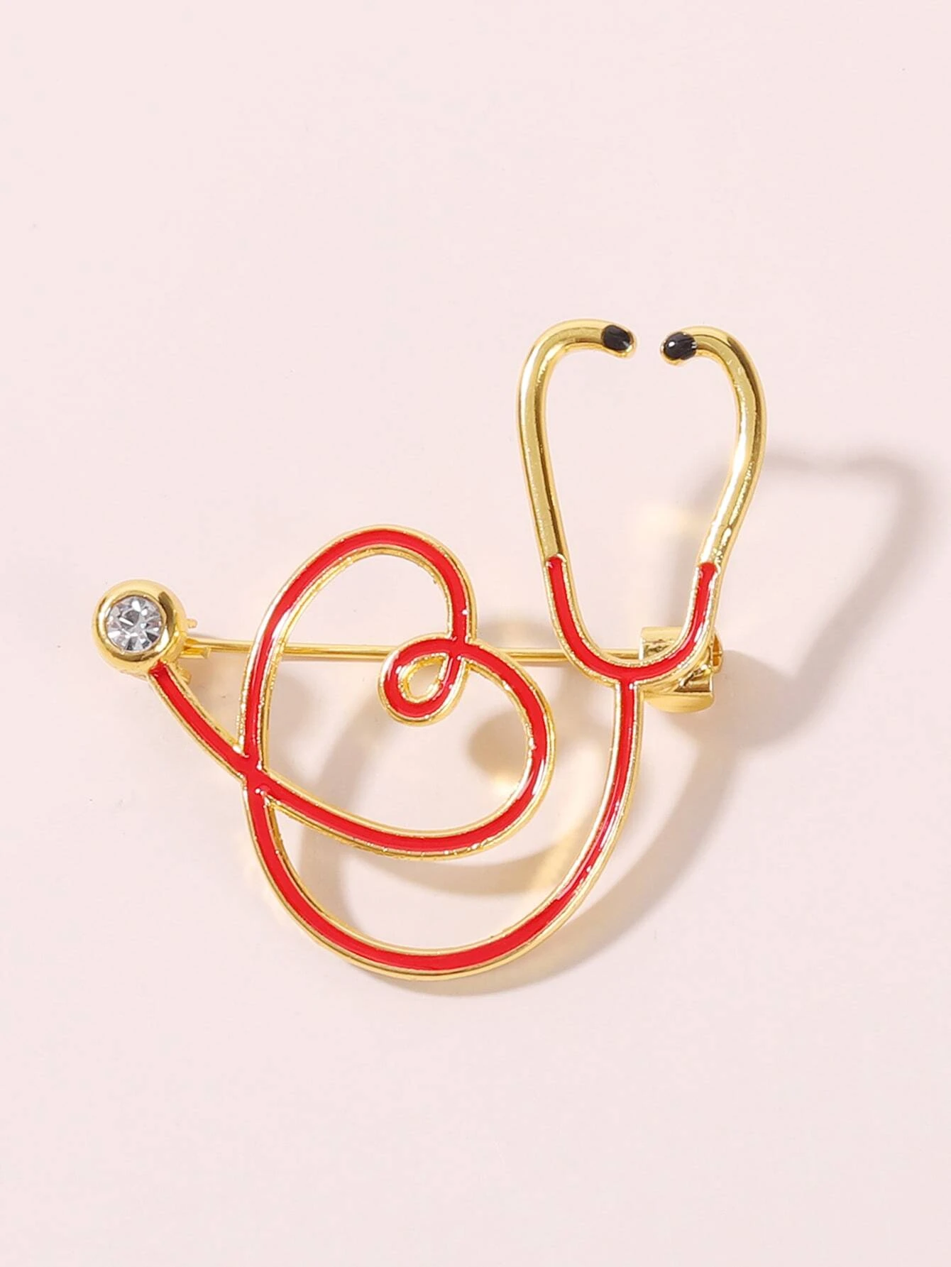 Brooch featuring a stethoscope design, a symbolic and stylish accessory for healthcare professionals or those who appreciate their dedication.