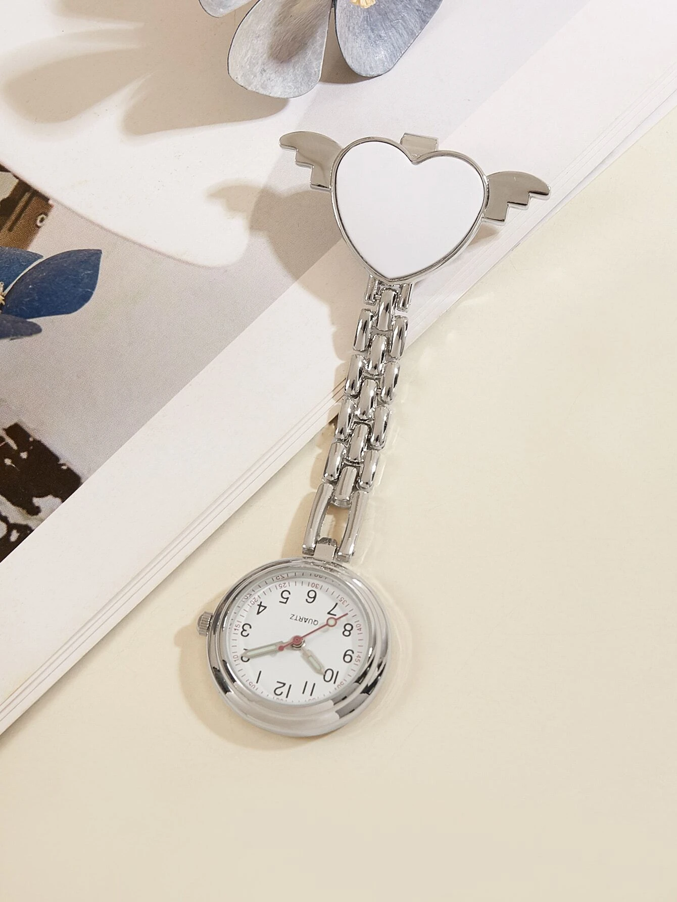 Quartz watch brooch featuring a heart and nurse design, combining style and functionality for a unique accessory suitable for healthcare professionals.