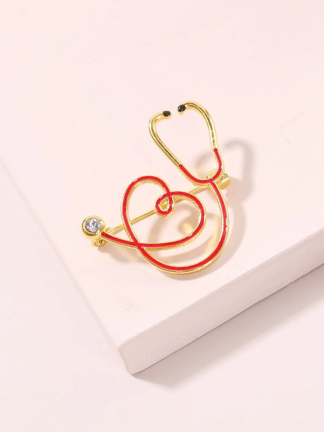 Brooch featuring a stethoscope design, a symbolic and stylish accessory for healthcare professionals or those who appreciate their dedication.
