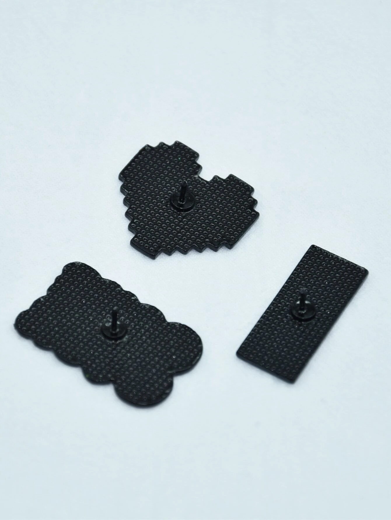 Set of three brooches featuring heart and letter designs, adding a romantic and personalized touch to your attire or accessories.