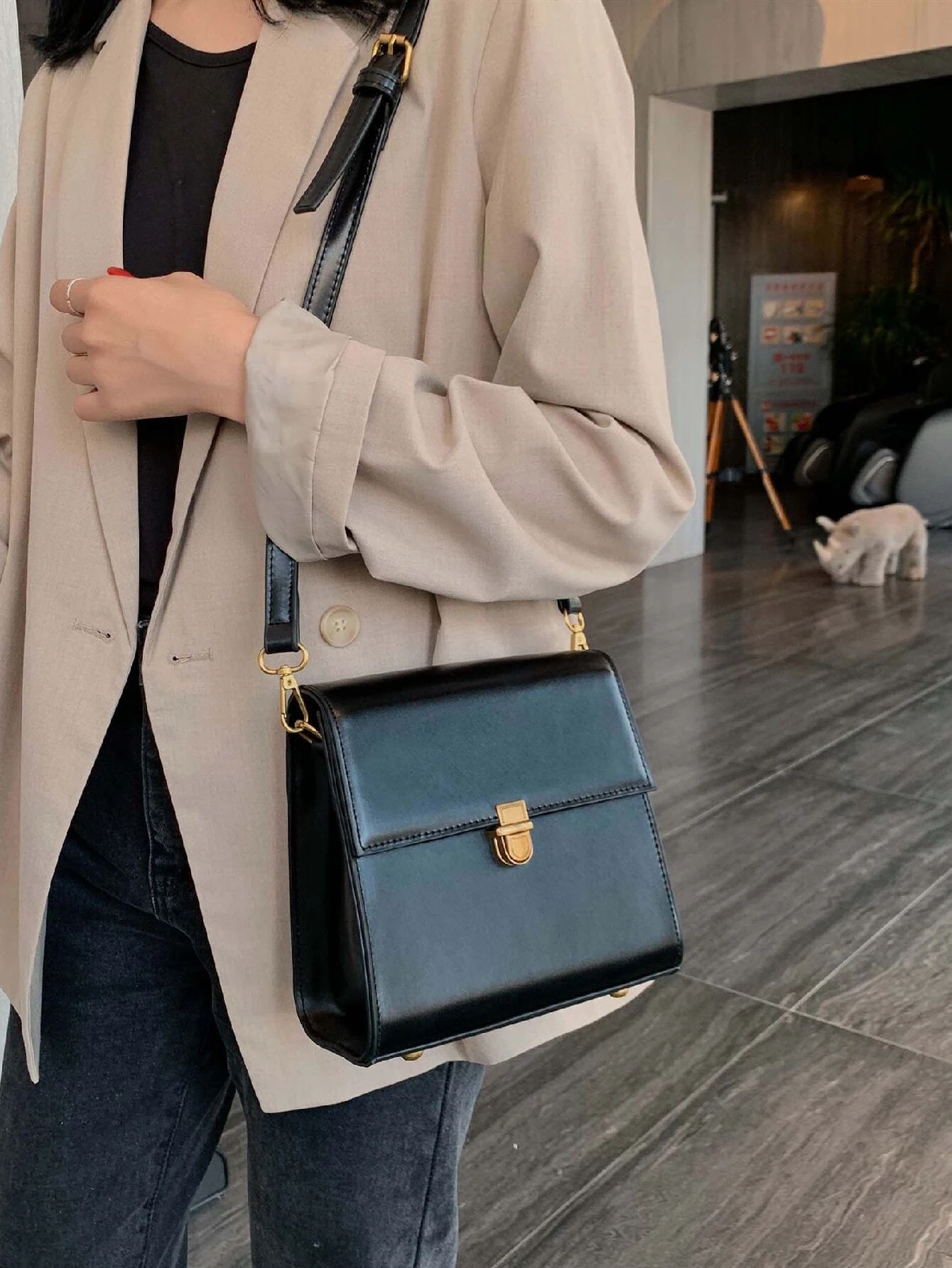 Mini square bag with minimalist design and snap button detail flap. This accessory combines simple elegance with functional embellishments, offering a chic and versatile way to carry your essentials.