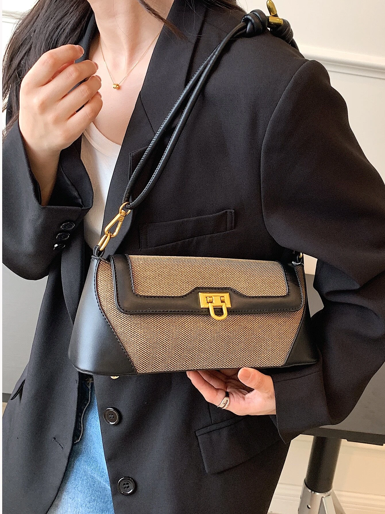 Two-tone flap baguette bag with a blend of colors. This accessory offers a sleek and stylish way to carry your essentials, embodying modern elegance and functionality.
