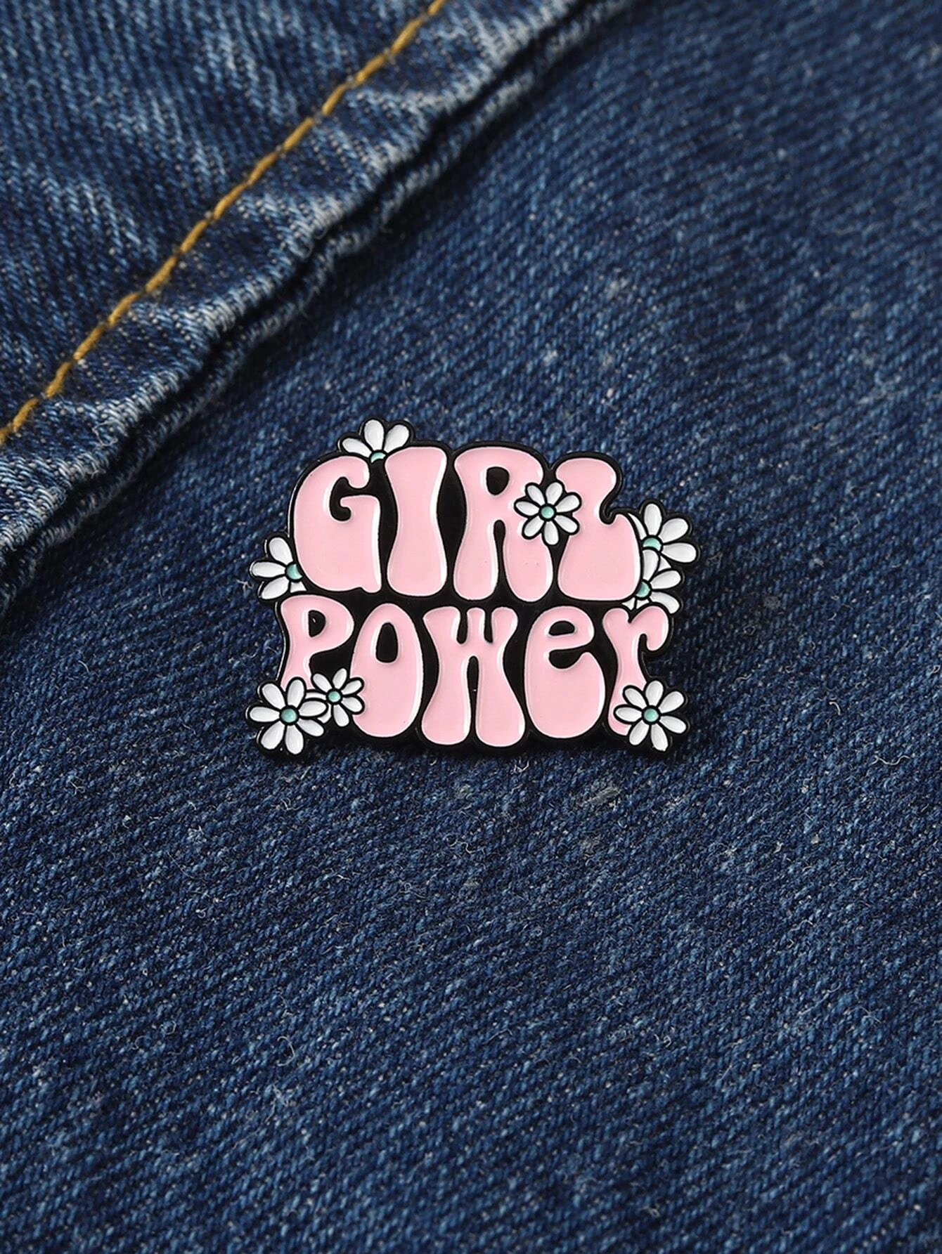 Brooch combining floral motifs and decorative letters, creating a harmonious and stylish accessory with a touch of personalized charm.