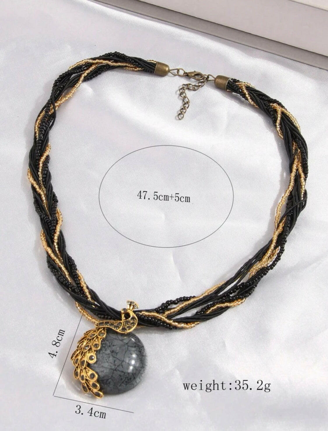 Add a timeless touch of sophistication to your wardrobe with this classic black vintage peacock shaped pendant necklace. Crafted with a stunning rhinestone-encrusted design and an exquisite gold chain, this elegant piece is the perfect accessory for your special occasions.