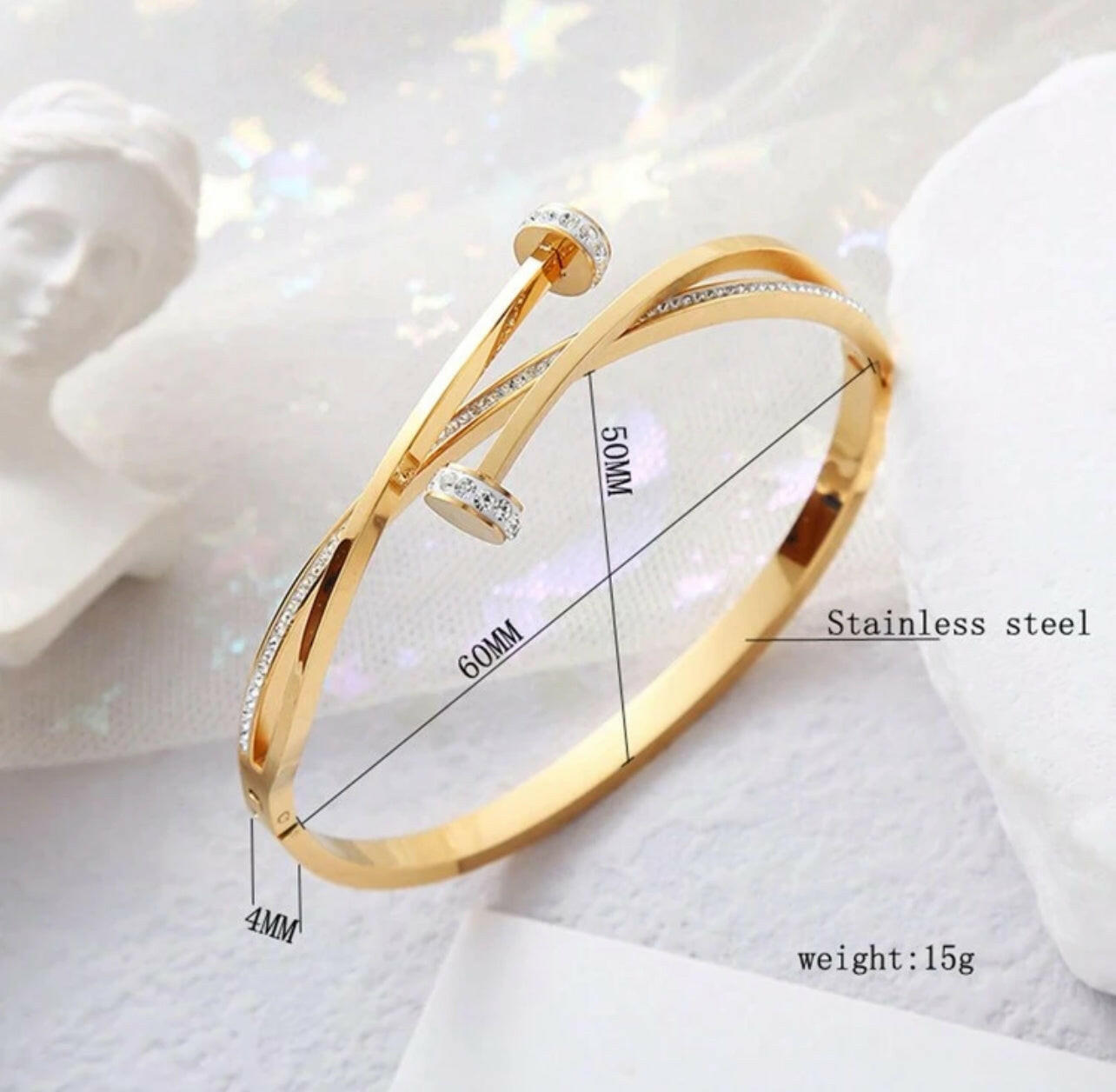 This stylish 1pc Minimalist Design Bangle features a nail pattern and unique cross embellished with sparkling rhinestones. Crafted from stainless steel, this timeless piece is perfect for everyday wear.