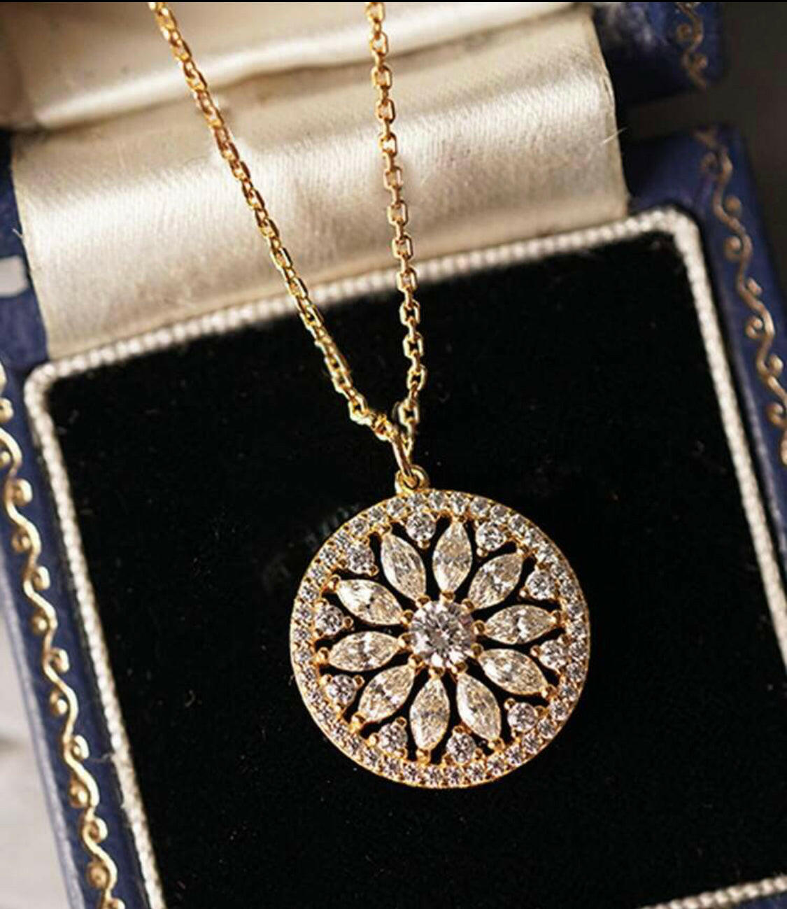 This stylish pendant necklace is crafted from gold-plated sterling silver and inlaid with sparkling cubic zirconia stones. The eye-catching sunflower design brings a hint of nature to your outfit. A perfect accessory for any special occasion.