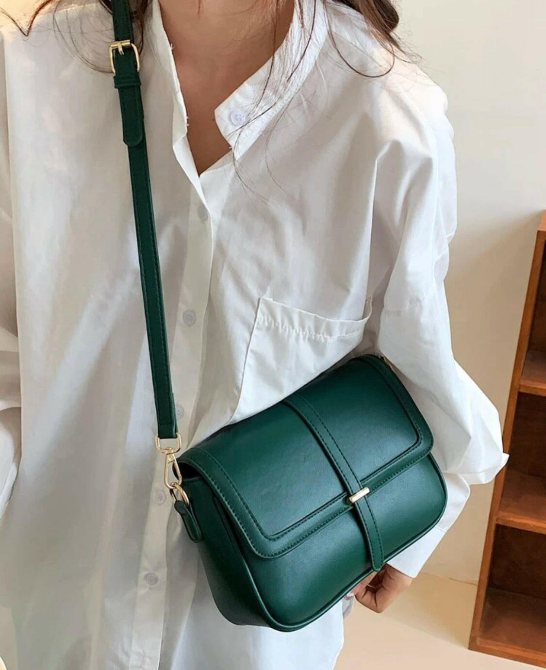This eye-catching Green Metal Detail Flap Square Bag features a chic metallic trim and a contemporary square silhouette, making it the perfect addition to any wardrobe. The spacious interior is ideal for storing everyday items, and the hardware detail adds an edgy finishing touch.