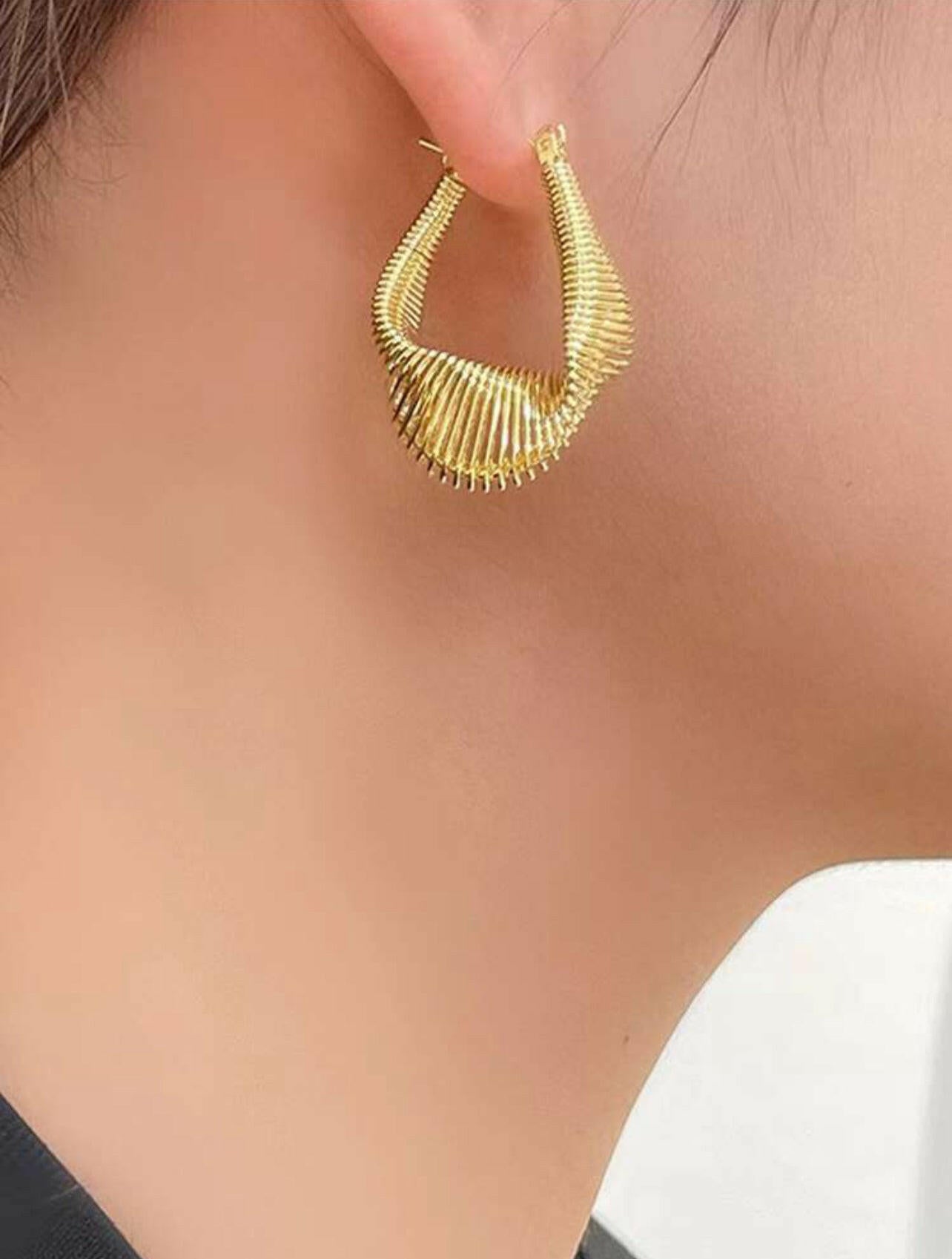 Add a touch of elegance to your outfit with our Elegant Twisted Irregular Coil Design Gold-plated Stainless Steel Earrings. Made from high-quality stainless steel, these earrings feature a unique twisted coil design that is both stylish and durable. With a subtle gold-plated finish, these earrings are perfect for any occasion.