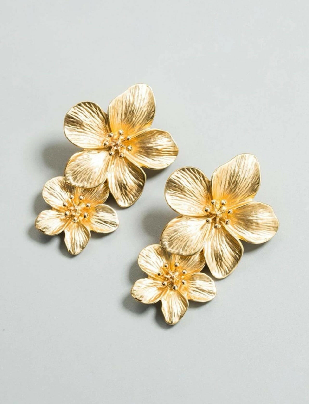 These elegant Flower Drop Earrings are the perfect accessory for any outfit. Made with high-quality materials, these earrings feature delicate and intricate flower designs that will add a touch of charm to your look. Elevate your style with these stunning earrings and make a statement wherever you go.
