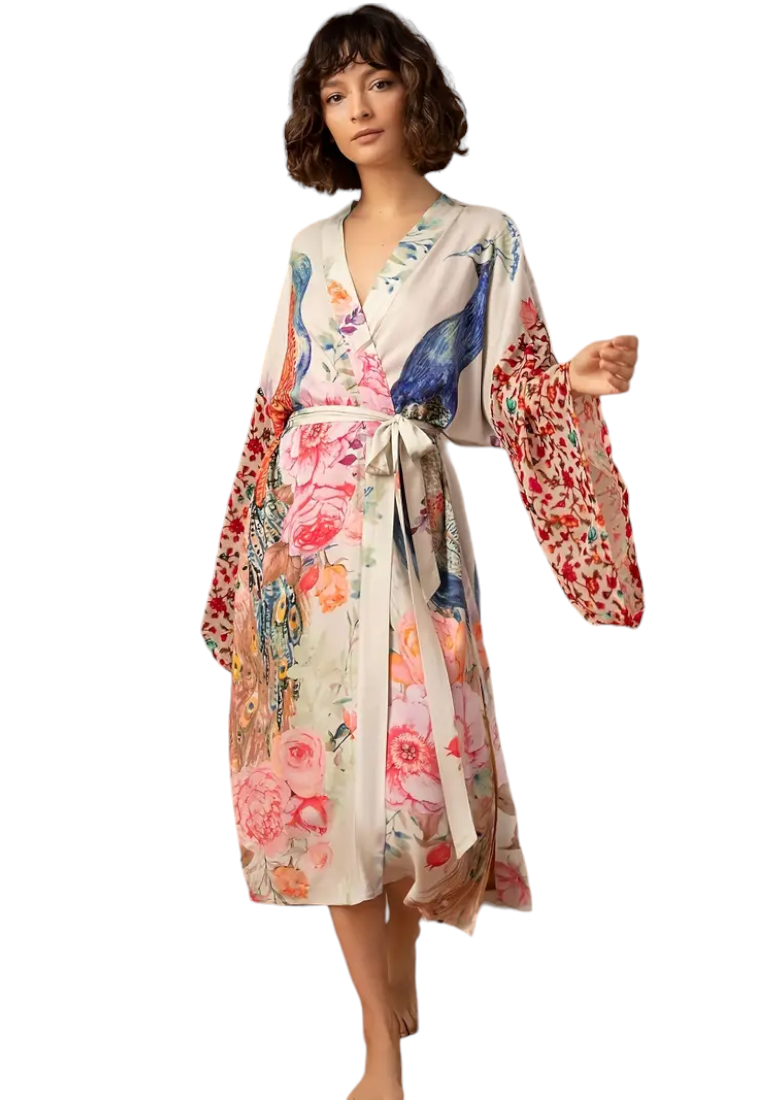 Add some flair to your beach vacation with our Floral Peacock Print Cover Up Kimono. Made with a vibrant and stylish floral peacock print, this cover up will ensure you stand out while providing coverage from the sun. Perfect for a day of lounging by the pool or a stroll on the beach.