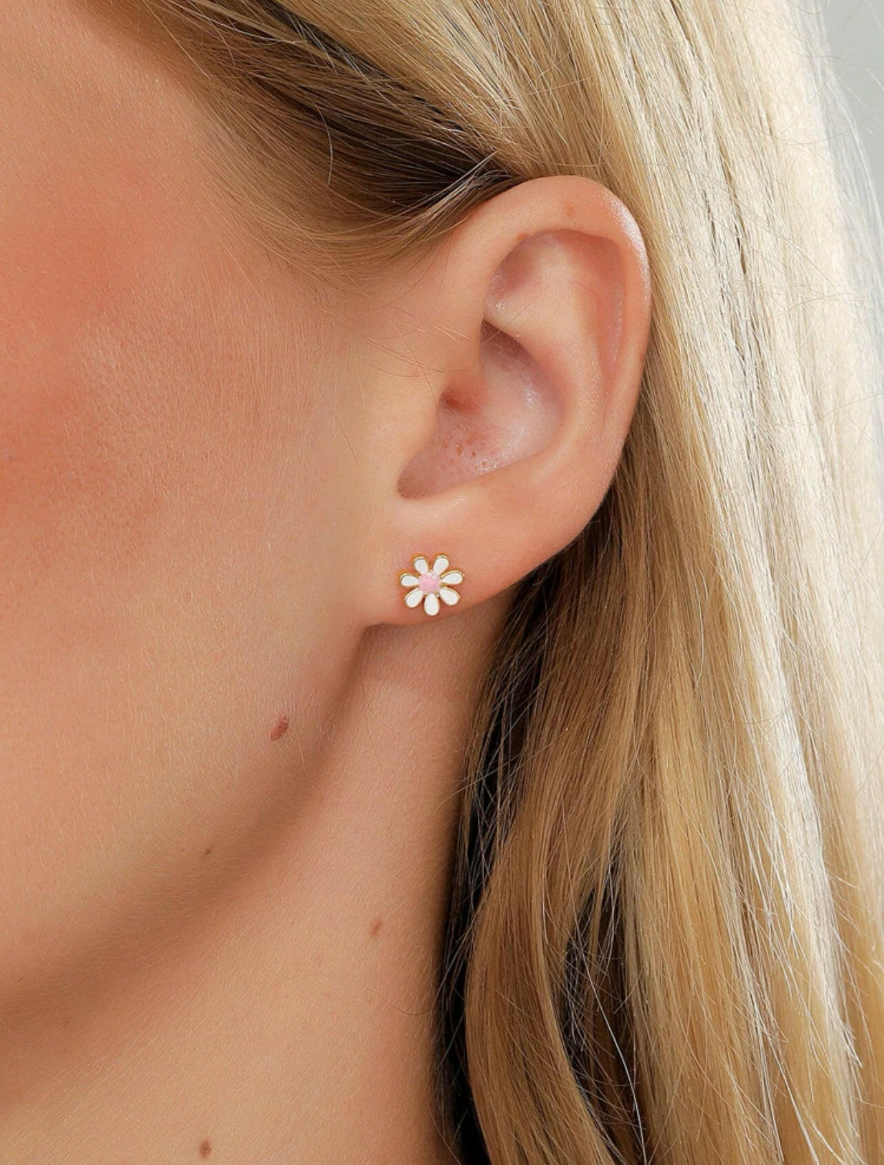 Add a touch of elegance and charm to any outfit with our Flower Decor Stud Earrings. These earrings feature a delicate flower design that will surely make a statement. Crafted with high-quality materials, they are durable and long-lasting, making them perfect for everyday wear or special occasions. Elevate your style with these stunning earrings now!