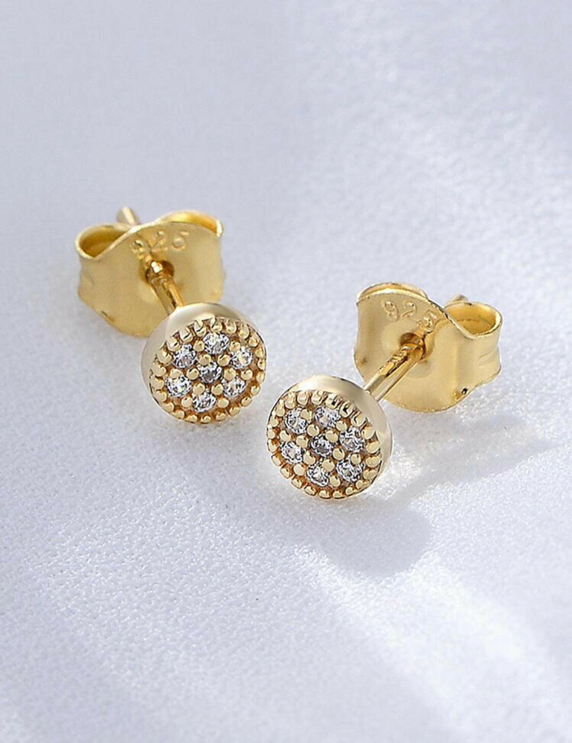 These classic cubic zirconia round decor sterling silver stud earrings are the perfect accessory for any outfit. Carefully crafted with 925 sterling silver, these earrings boast an eye-catching sparkle and shine. Studs are a timeless style that look beautiful for any occasion.