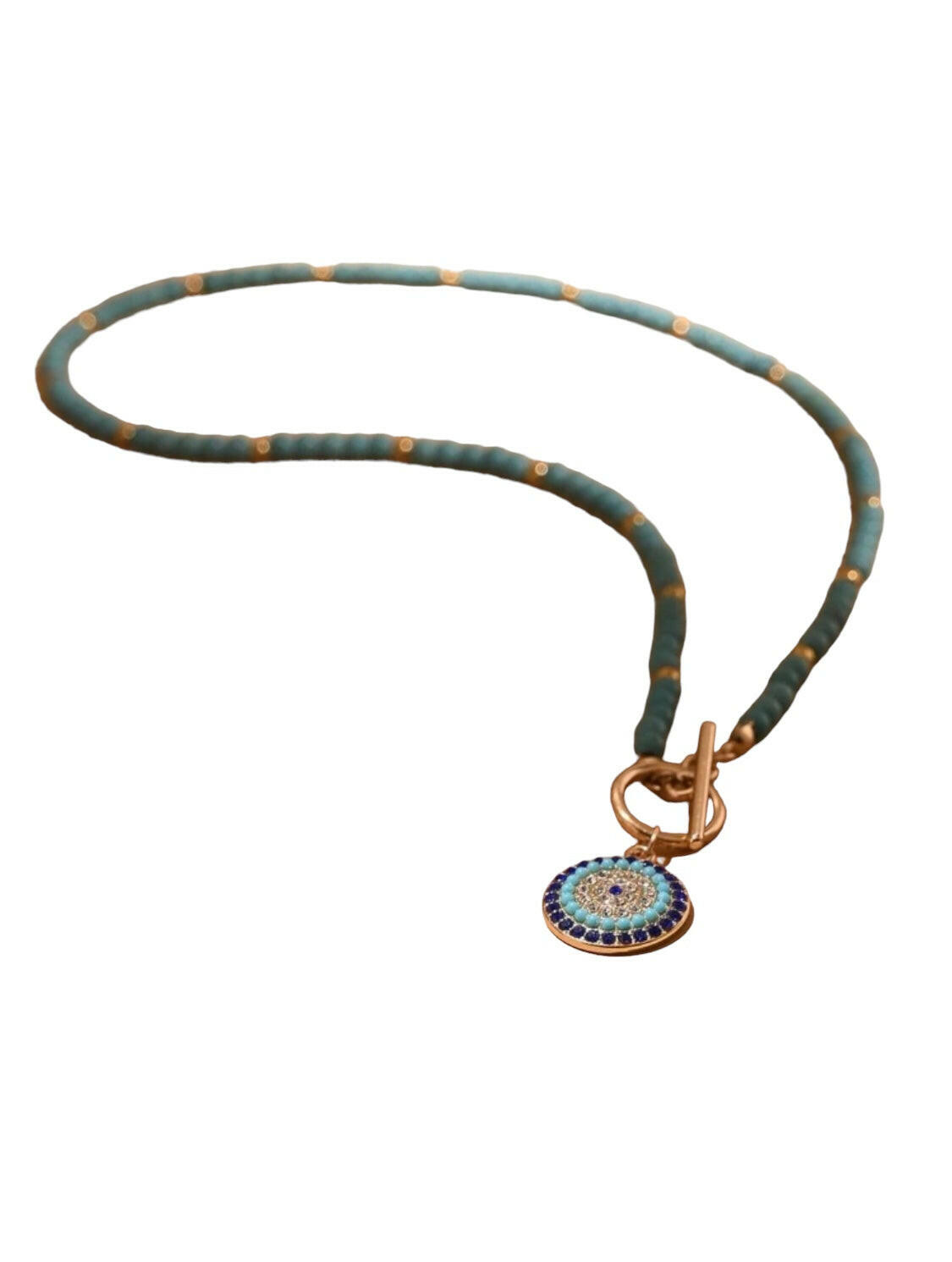 This Eye Detail Round Charm Beaded Necklace offers elegant detailing, with a beaded charm for a standout look. The 18 inch necklace is composed of a durable alloy chain and an eye charm, for a sophisticated statement piece. The charm features a secure clasp closure, making it a reliable accessory for any occasion.