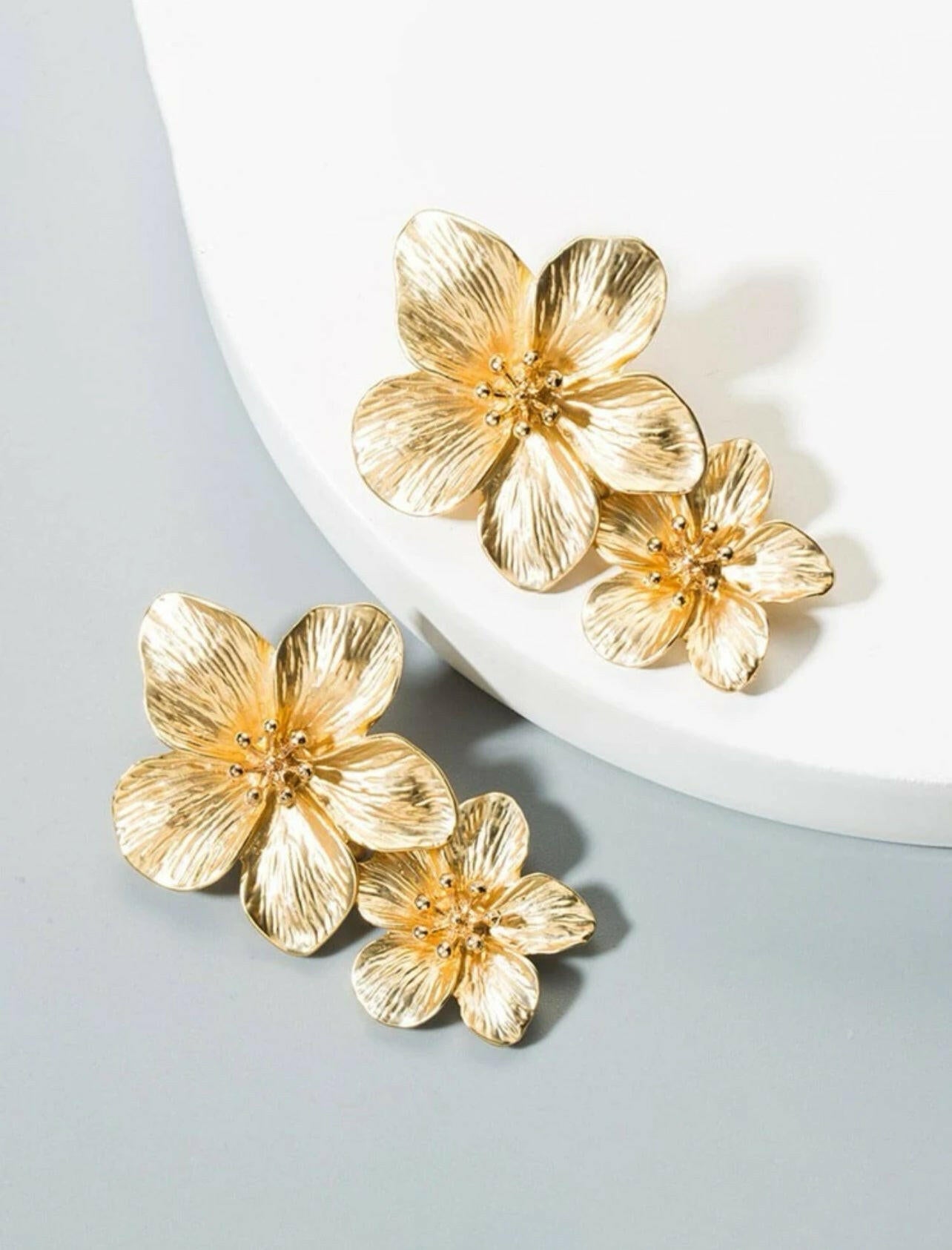 These elegant Flower Drop Earrings are the perfect accessory for any outfit. Made with high-quality materials, these earrings feature delicate and intricate flower designs that will add a touch of charm to your look. Elevate your style with these stunning earrings and make a statement wherever you go.