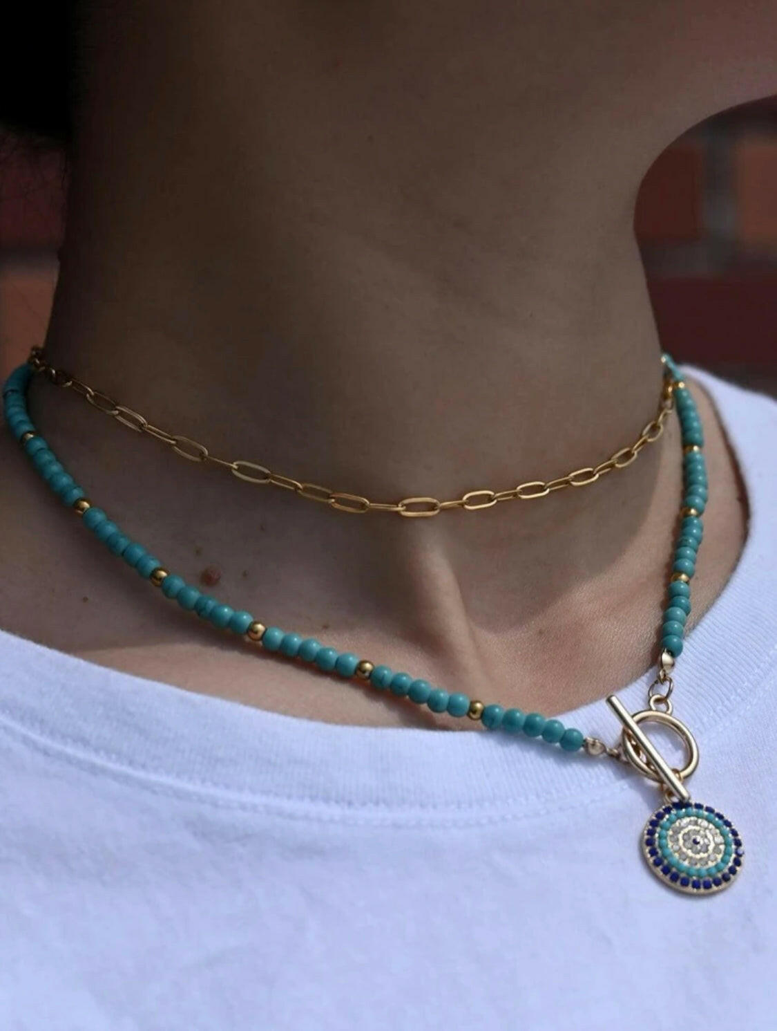 This Eye Detail Round Charm Beaded Necklace offers elegant detailing, with a beaded charm for a standout look. The 18 inch necklace is composed of a durable alloy chain and an eye charm, for a sophisticated statement piece. The charm features a secure clasp closure, making it a reliable accessory for any occasion.