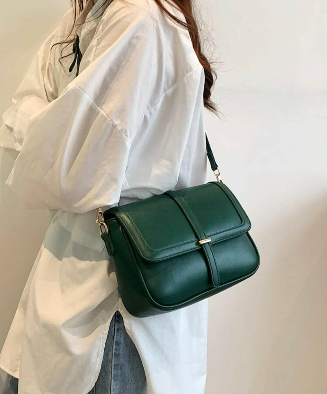 This eye-catching Green Metal Detail Flap Square Bag features a chic metallic trim and a contemporary square silhouette, making it the perfect addition to any wardrobe. The spacious interior is ideal for storing everyday items, and the hardware detail adds an edgy finishing touch.