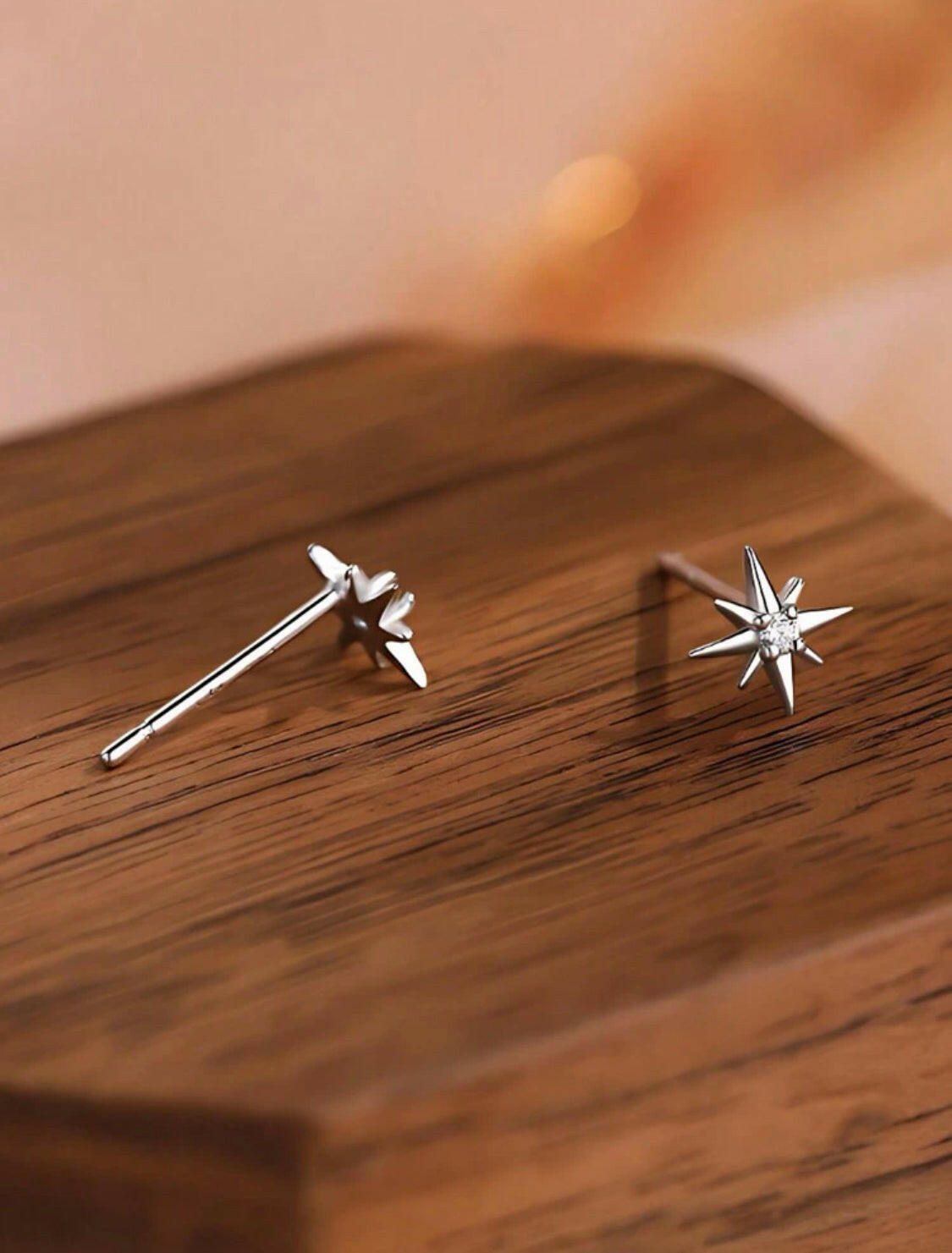 These Sterling Silver Cubic Zirconia earrings feature an eight-pointed star design, perfectly symmetrical and dazzlingly polished. Crafted with 925 silver to ensure quality and durability, they are a timeless addition to any collection.
