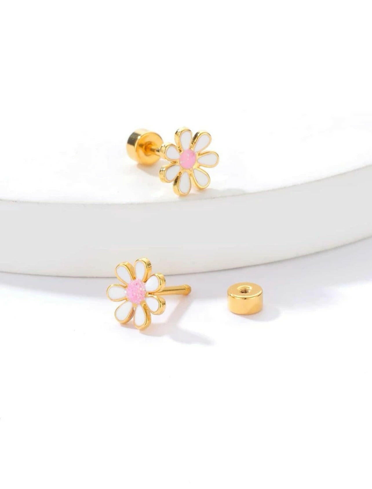 Add a touch of elegance and charm to any outfit with our Flower Decor Stud Earrings. These earrings feature a delicate flower design that will surely make a statement. Crafted with high-quality materials, they are durable and long-lasting, making them perfect for everyday wear or special occasions. Elevate your style with these stunning earrings now!