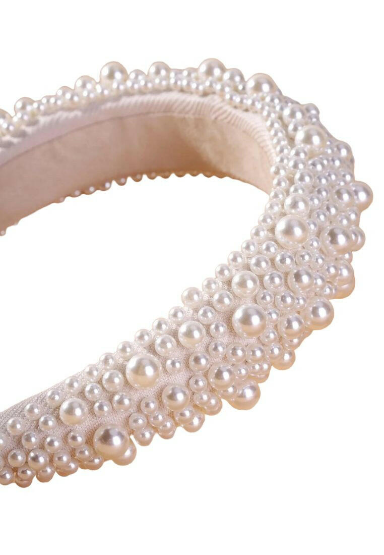 Wide headband adorned with white faux pearls, offering a chic and stylish accessory to elevate your hair look.