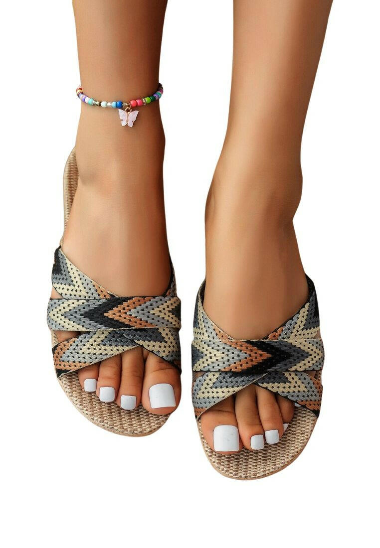 Colorful and stylish cross strap linen slides featuring a mix of vibrant blocks. The crisscrossing straps provide a comfortable fit while adding a touch of flair to the design. Perfect for casual outings and warm-weather relaxation.