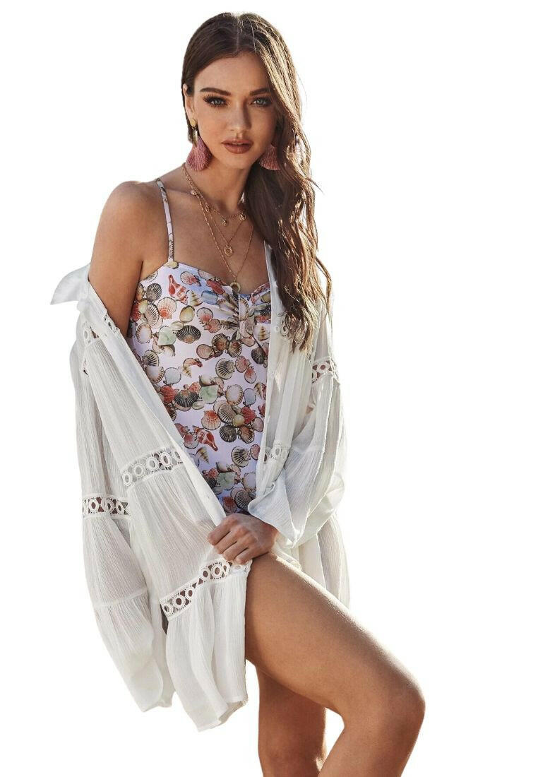 Circle lace insert bell sleeve layered cover-up, a chic and airy beachwear accessory. This cover-up features flowing bell sleeves and intricate circle lace inserts. Its layered design adds a touch of dimension, perfect for wearing over swimwear. The combination of textures and the open front style create a stylish look, ideal for enhancing your beach ensemble.