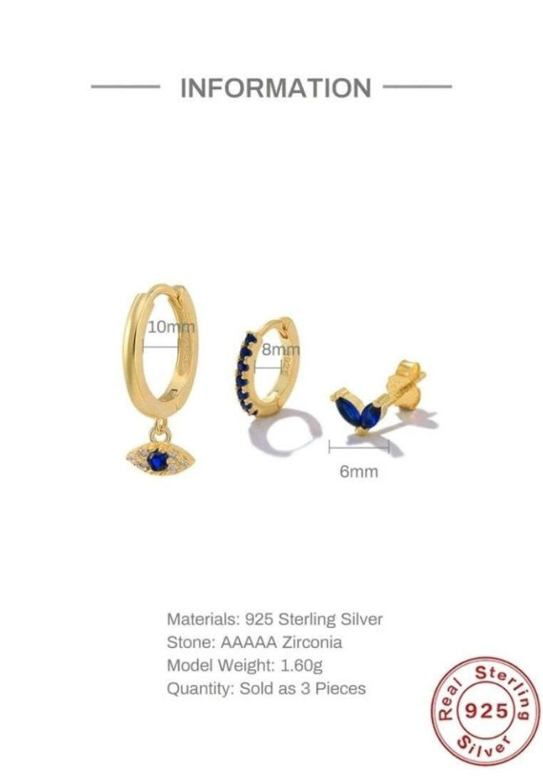 A set of three fashionable silver earrings featuring cubic zirconia and eye decorations. The earrings showcase a combination of sparkling cubic zirconia stones and intricate eye motifs. The silver setting adds a touch of elegance, while the unique design brings a mix of glamour and symbolism to these versatile accessories.