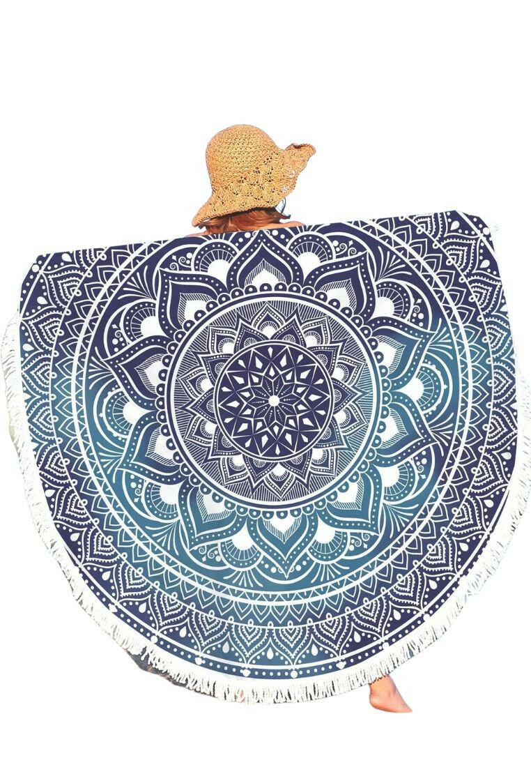 A boho beach towel with a blue ombre mandala print and fringe trim. The towel features a gradient of blue colors in a mandala pattern, with fringe trim along the edges. This towel is stylish and versatile, suitable for beach outings or outdoor relaxation. The blue ombre design and fringe trim add a touch of bohemian flair to the towel.