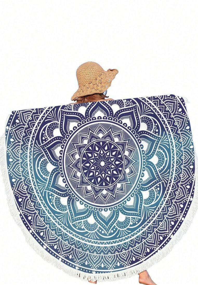 A boho beach towel with a blue ombre mandala print and fringe trim. The towel features a gradient of blue colors in a mandala pattern, with fringe trim along the edges. This towel is stylish and versatile, suitable for beach outings or outdoor relaxation. The blue ombre design and fringe trim add a touch of bohemian flair to the towel.