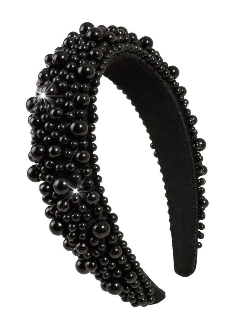 A black headband adorned with bead decorations, offering a chic and stylish accessory for your hair.