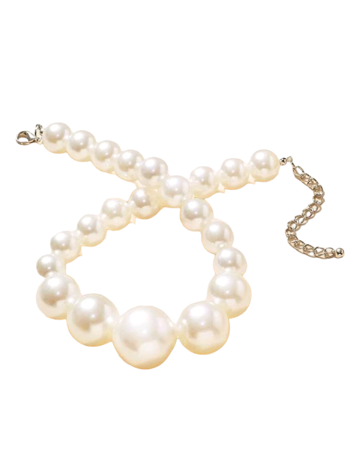 Stunning faux pearl beaded necklace with lustrous, creamy-white spherical beads arranged in a classic and timeless design. The necklace is a graceful and elegant accessory, perfect for adding a touch of sophistication to any outfit.