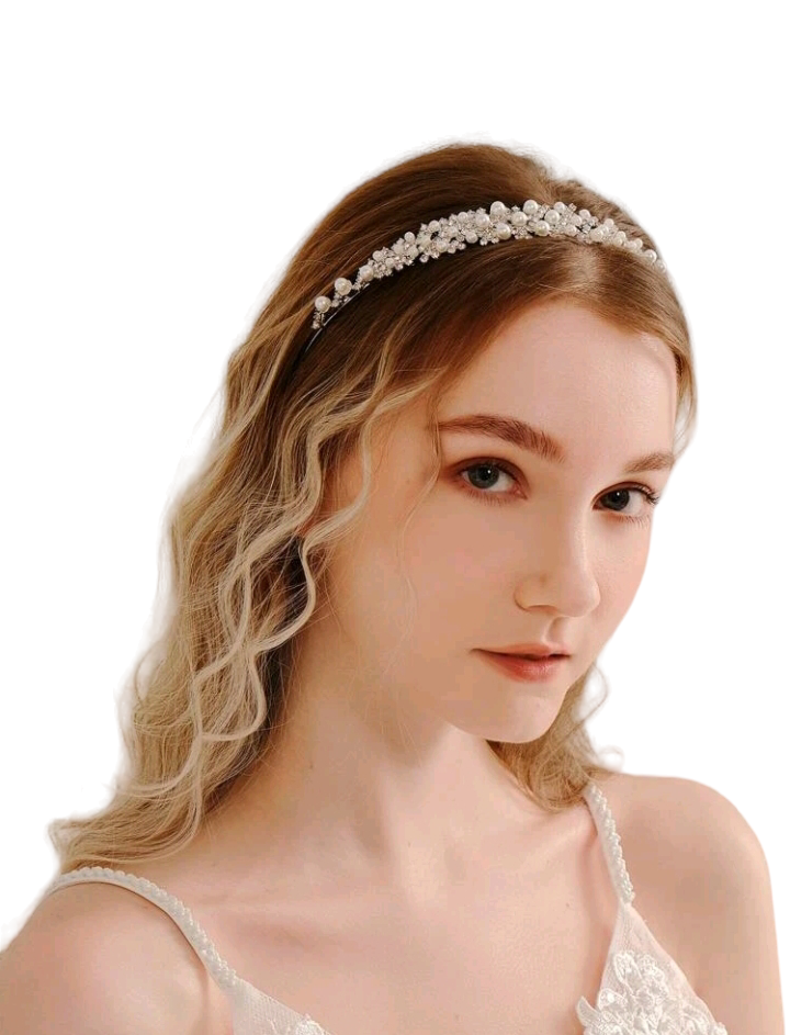 A bridal headband adorned with rhinestones and faux pearls, creating an exquisite and elegant accessory that adds a touch of timeless beauty and sophistication to a bride's ensemble.